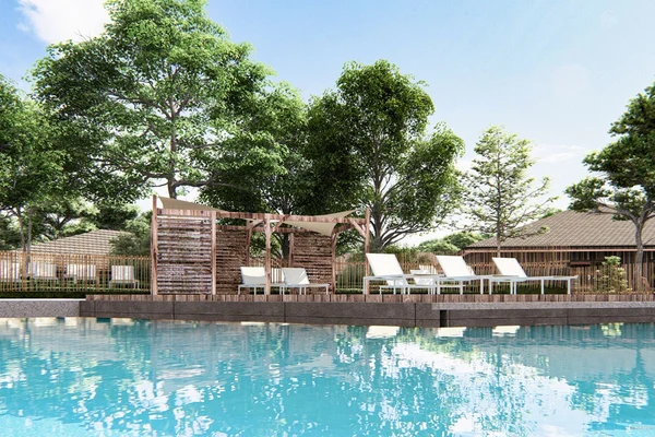 At Ondres Plage, wooden recliners sit beside a tranquil pool, encircled by trees and cabins.